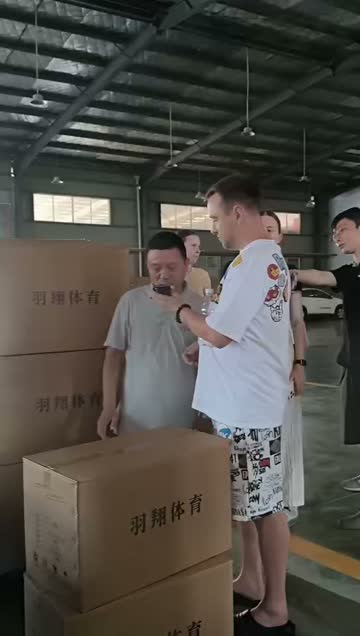Overseas visitor reviewing cartons at a partner production site